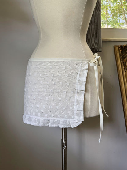 White lace skirt on a mannequin against a neutral background