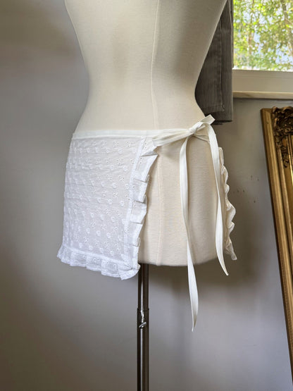White lace skirt on a mannequin against a neutral background