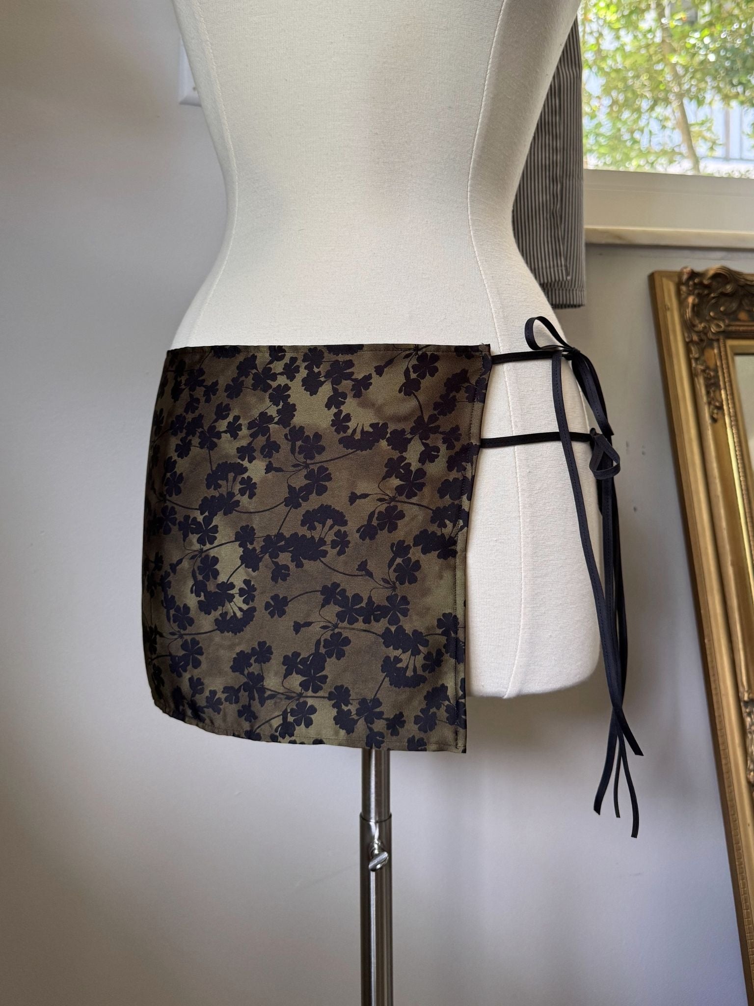 Floral-patterned skirt on a mannequin against a neutral background