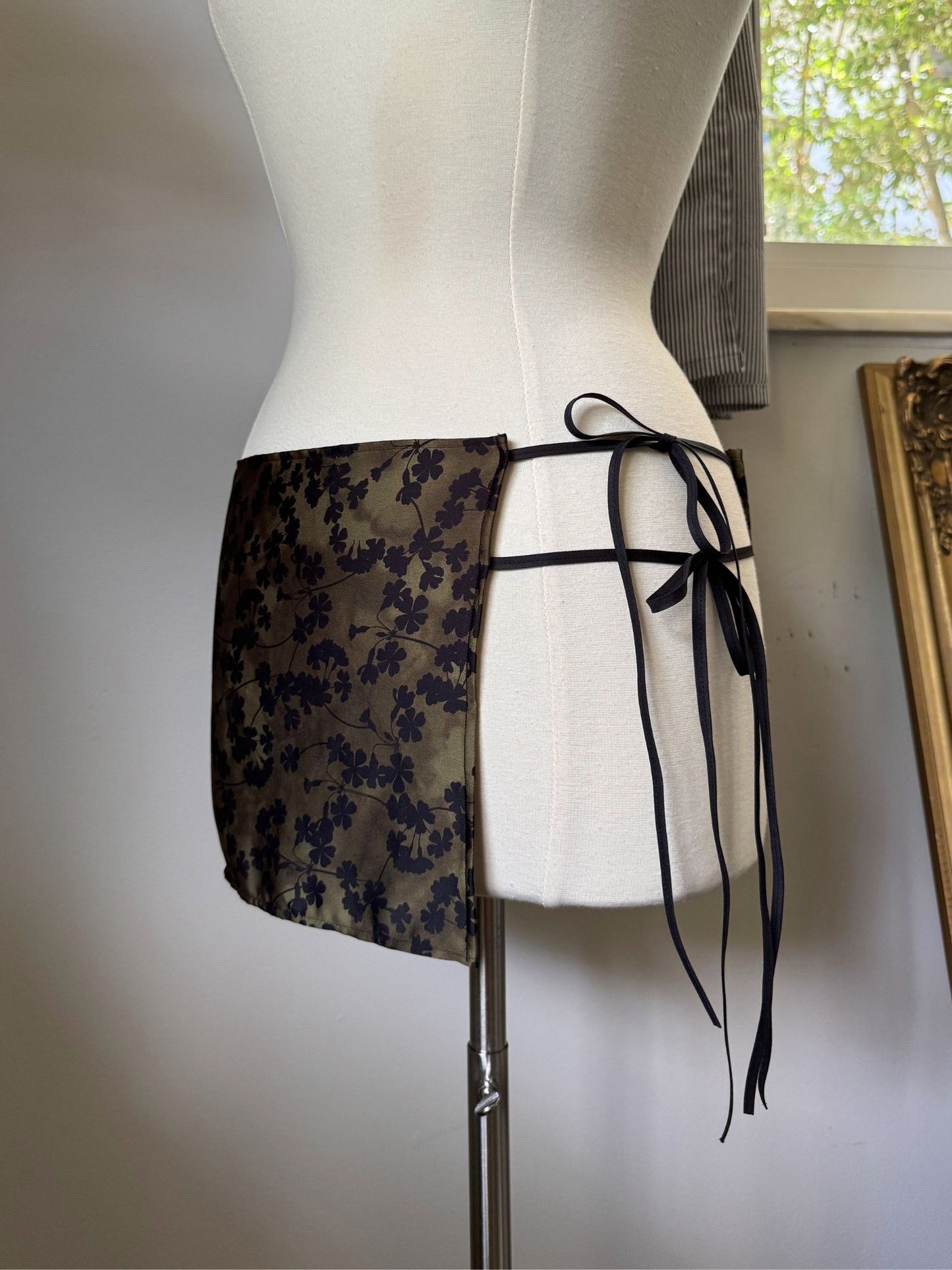 Floral-patterned skirt on a mannequin against a neutral background