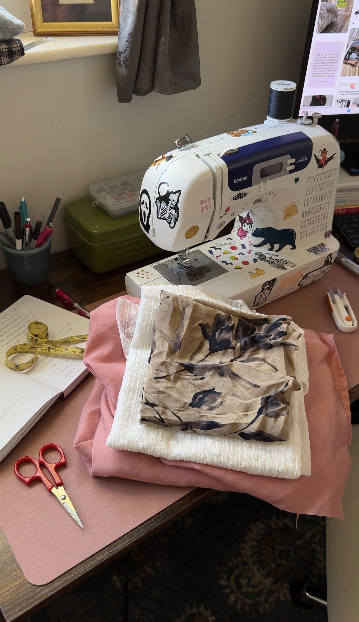 Sewing machine on a table with fabric and scissors